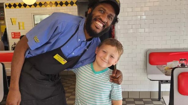 Kayzen Hunter, 8, along with waiter and dad-of-two Devonte Gardner