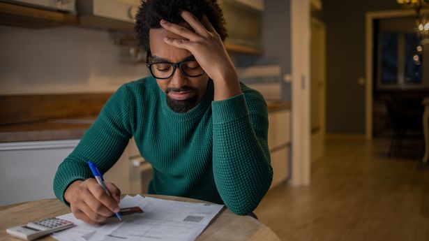 Young man paying bills