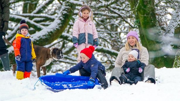 People play in the snow on the hills of Buxton, Derbyshire