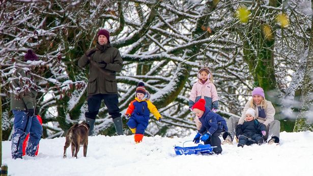 People play in the snow on the hills of Buxton, Derbyshire