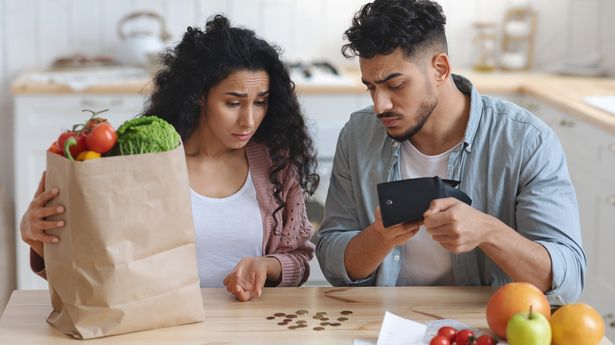 Family Financial Crisis Concept. Upset Spouses Counting Remaining Money After Shopping, Young Middle Eastern Couple Shocked About Big Prices For Grocery, Looking At Empty Wallet At Home