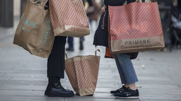 Customers with shopping bags after visiting a Primark clothing store