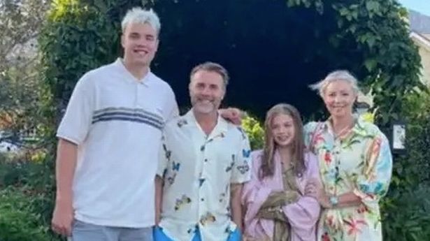 Gary Barlow, 52, his wife Dawn, 53, their son Daniel, 22 and their teenage daughter Daisy, 13, posing together in a garden.