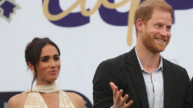 Britain's Meghan (L), Duchess of Sussex, Britain's Prince Harry (C), Duke of Sussex